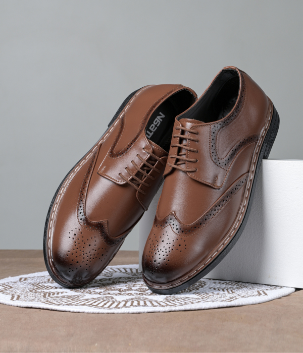 Brown leather shoes on a gray background